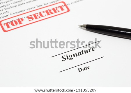 Sign name on document with black pen