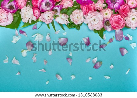 Beautiful floral background, texture, wallpaper. Flat-lay of pink flowers on blue background, top view, copy space greeting card or wedding invitation