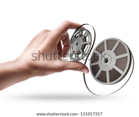 Man's hand holding Cinema film roll and strip isolated on white background