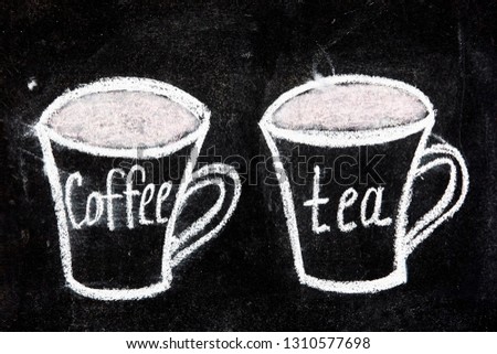 cup of tea and cup of coffee drawing by white chalk on black chalkboard closeup, idea of menu cafe

