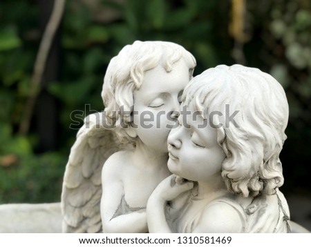 Couple cupids sculpture kissing close up. Valentine background Royalty-Free Stock Photo #1310581469
