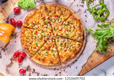 Fresh pizza with tomatoes, cheese and mushrooms on wooden table closeup  Pizza with pepperoni, tomatoes, cheese, olives and basil. 