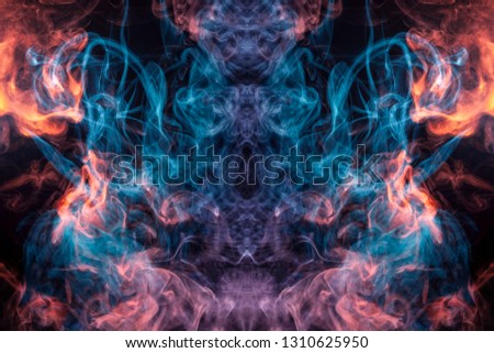 Cloud of red and blue  smoke  in the form of a skull, monster, dragon  on a black isolated background. Background from the smoke of vape. Mocap for cool t-shirts
