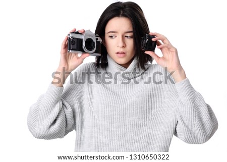 Portrait of a smiling young woman holding retro camera