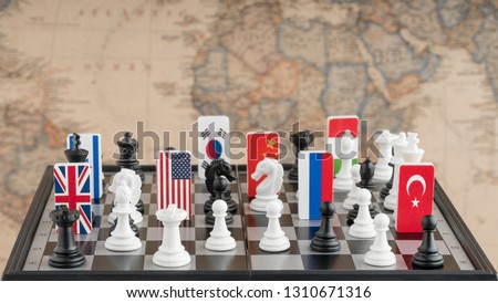 Country flag symbols on the chessboard with figures on the background of the political map of the world. Conceptual photo of a political game.