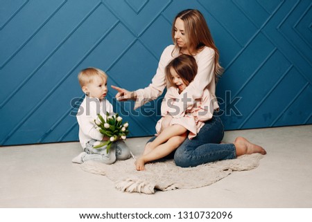 Children give mother flowers. Family at home. Mothers day