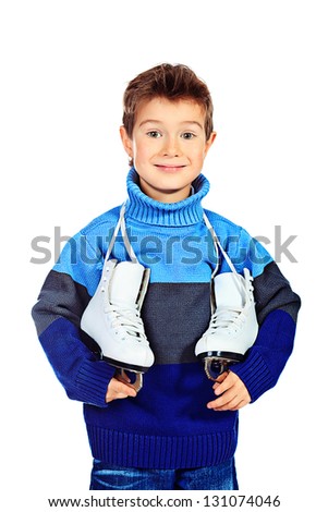 Cheerful little boy in warm sweater holding figure skates. Isolated over white background
