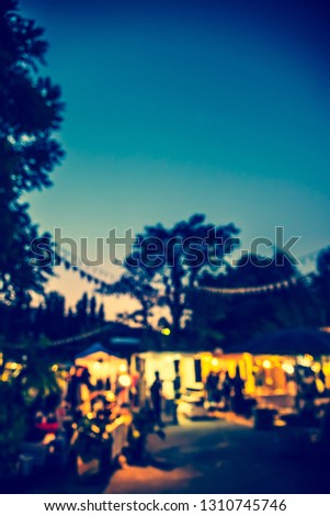 Vintage tone abstract blur image of Street Night market in garden with bokeh for background usage .