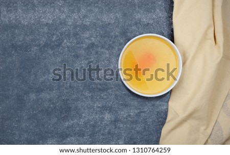 Creative layout made of broth and napkin on grey background. Rich in protein, specifically gelatin and  contain minerals calcium and phosphorus.Food concept.Image with copy space.