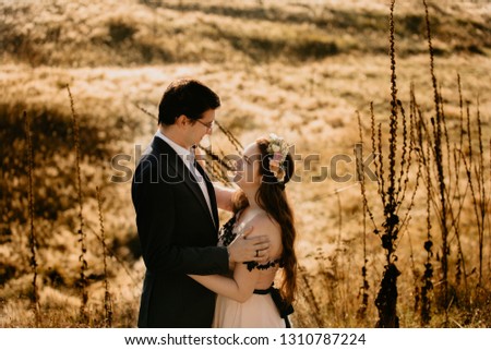 Beautiful wedding couple posing in green yard