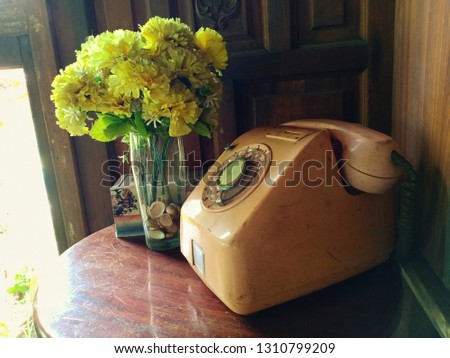 old home telephone on wooden table , vintage