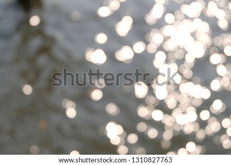 Blurry light spots, bokeh. Light reflection on the water river, Abstract background of defocused