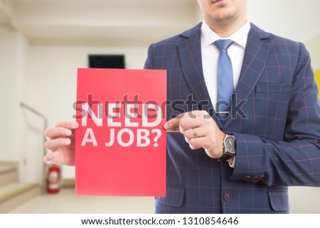 Businessman showing need a job question on red paper as advertising hiring concept