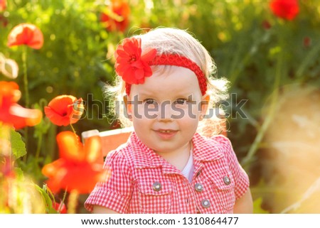 happy girl in poppy field on nature background in summer