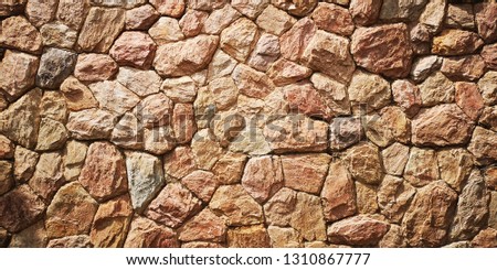 Beautiful shot of red brown rock mosaic wall. backgrounds/textures.