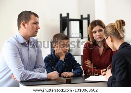 Divorced parents with their son visiting lawyer. Concept of child support Royalty-Free Stock Photo #1310868602