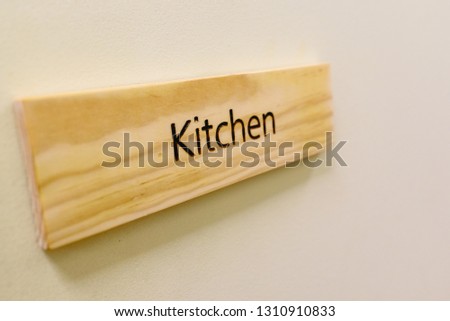 Wooden sign with the word Kitchen.