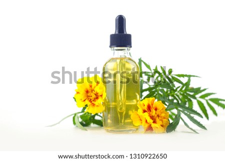 marigold essential oil in a beautiful bottle on the White background