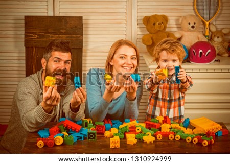 Little boy with dad and mom. happy childhood. Care and development. happy family and childrens day. father and mother with child play constructor. little boy play with parents at home. Family photos.