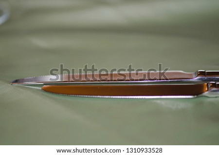 Two knives on an elegant table cloth
