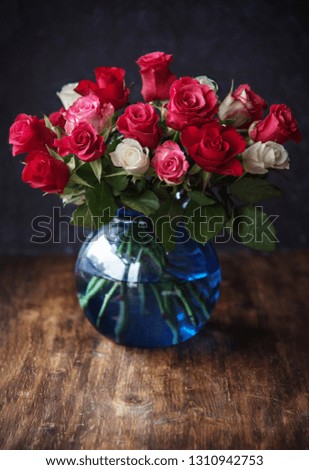 Beautiful roses in vase on the table. Place for text