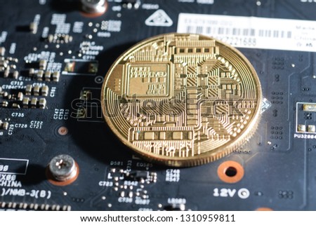 Royalty high quality free stock photo of close up Gold bitcoin electronic coin icon is on an electronic circuit board. Cryptocurrency golden bitcoin coin