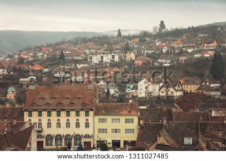 City landscape in Sighisoara with cityscape mountains in the background in Transylvania, Romania