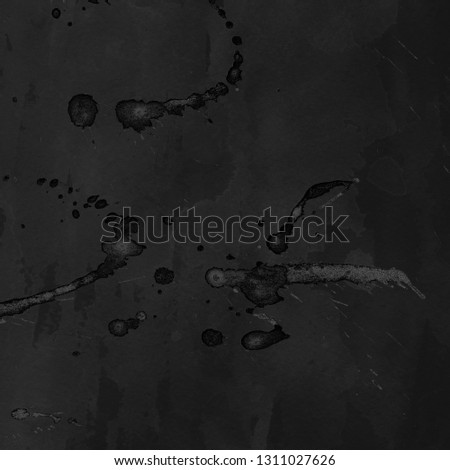 Black with gray paint splatter effect texture on gray paper background. Artistic backdrop. Different paint drops.