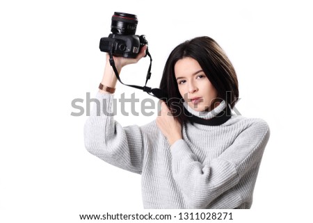 Young beautiful woman photographer taking images with camera
