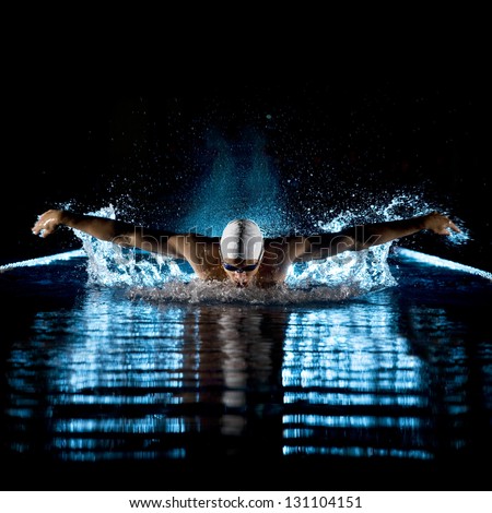 Taking breath swimming butterfly isolated black background Royalty-Free Stock Photo #131104151