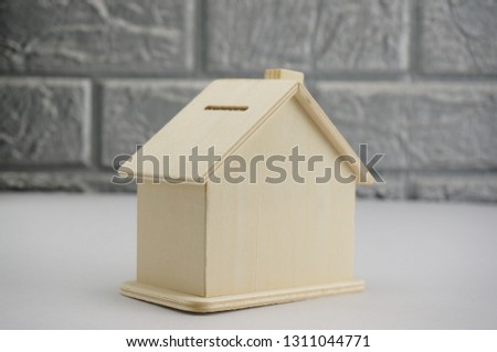 Conceptual photo  by using small scale of house model depicting related issue on financing and investment. Selectively focused and isolated.