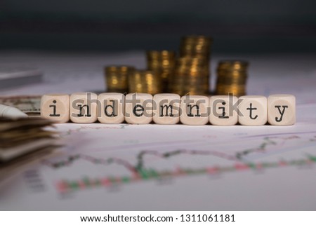 Word INDEMNITY composed of wooden letter. Stacks of coins in the background. Closeup Royalty-Free Stock Photo #1311061181