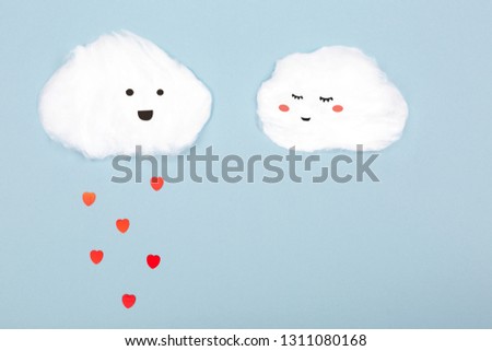 Two clouds made from cotton wool on blue background. Valentine day and love creative concept. Flat-lay, top view. Copy space for text.