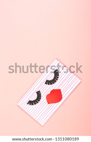 Creative love or Valentine day background made with cute envelope. Eye lashes and red lips looklike a woman face. Love letter or message concept. Vertical shot. Flat-lay, top view. Copy space.