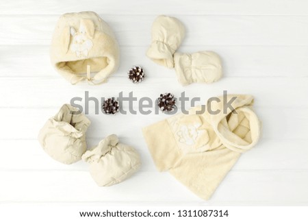 Set of children's winteror autumn clothes. scarf, hat, mittens and bootd on white background.