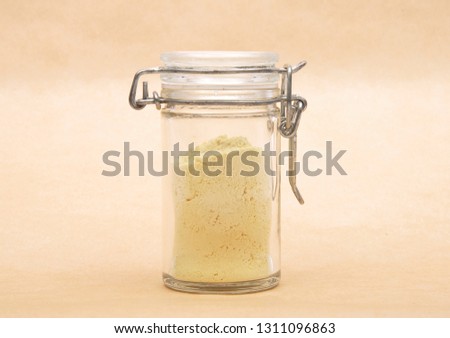 Lupin flour in closed jar on brown background