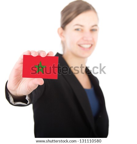 business woman holding a card with the Moroccan flag. With focus on the card
