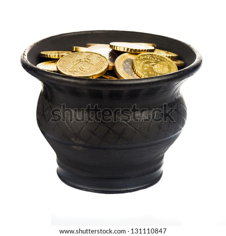 Black ceramic pot with golden coins isolated on white