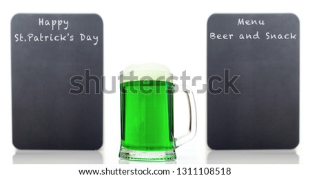 Big glass of green beer on the background gray two boards for text St. Patrick's Day and menu beer and snack -  concept holiday poster.