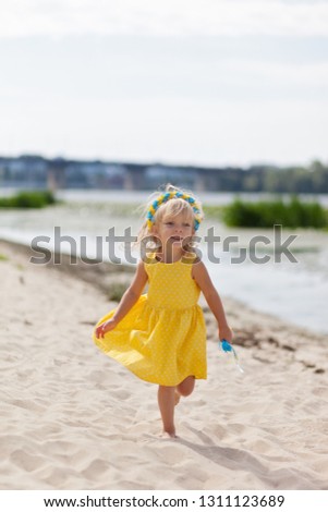 Little baby girl on the beach. Summer vacation