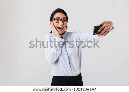 Image of pretty office woman wearing eyeglasses taking selfie photo on cell phone isolated over white background