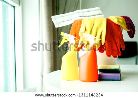 cleaning products in white bucket