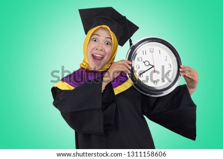 Beautiful Asian woman graduated showing and holding on clock to achieve degree, Education Concept
