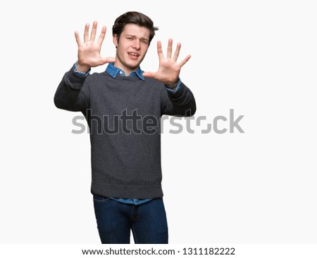 Young handsome elegant man over isolated background Smiling doing frame using hands palms and fingers, camera perspective