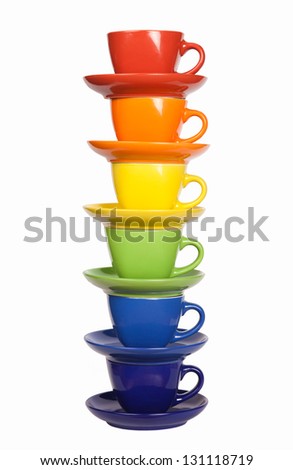 Colored tea cups and saucers, isolated on white.