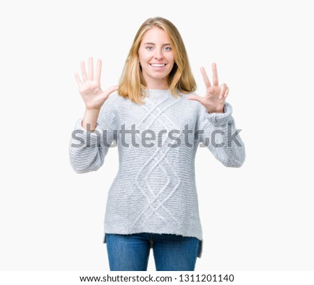Beautiful young woman wearing winter sweater over isolated background showing and pointing up with fingers number eight while smiling confident and happy.