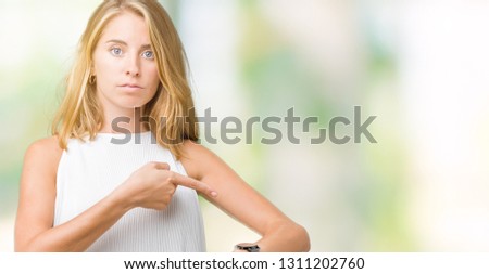 Beautiful young elegant woman over isolated background In hurry pointing to watch time, impatience, upset and angry for deadline delay