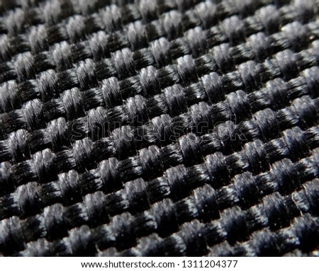 Macro shot of black fabric textile. Can be used as background or print for wallpaper