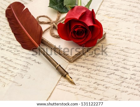 red rose, old letters and antique feather pen. sentimental vintage background. selective focus