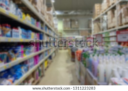 Blurred. View from the eyes of a visually impaired person. Rows of shelves and products in a mall or supermarket.
